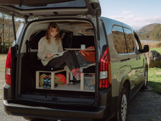 Micro camper conversion used as seating area with pop-up table