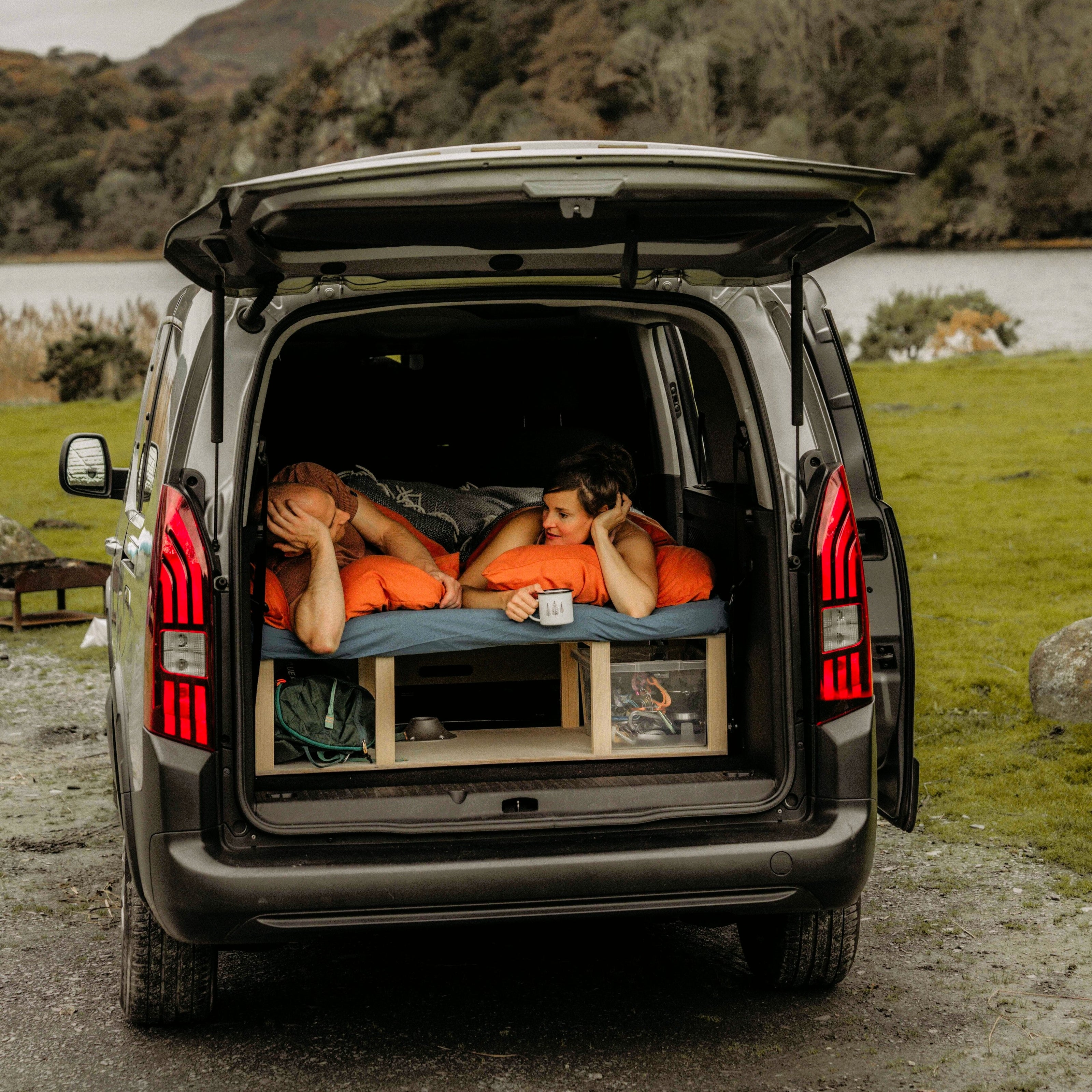 Camper conversion set up in sleep mode in a van. 