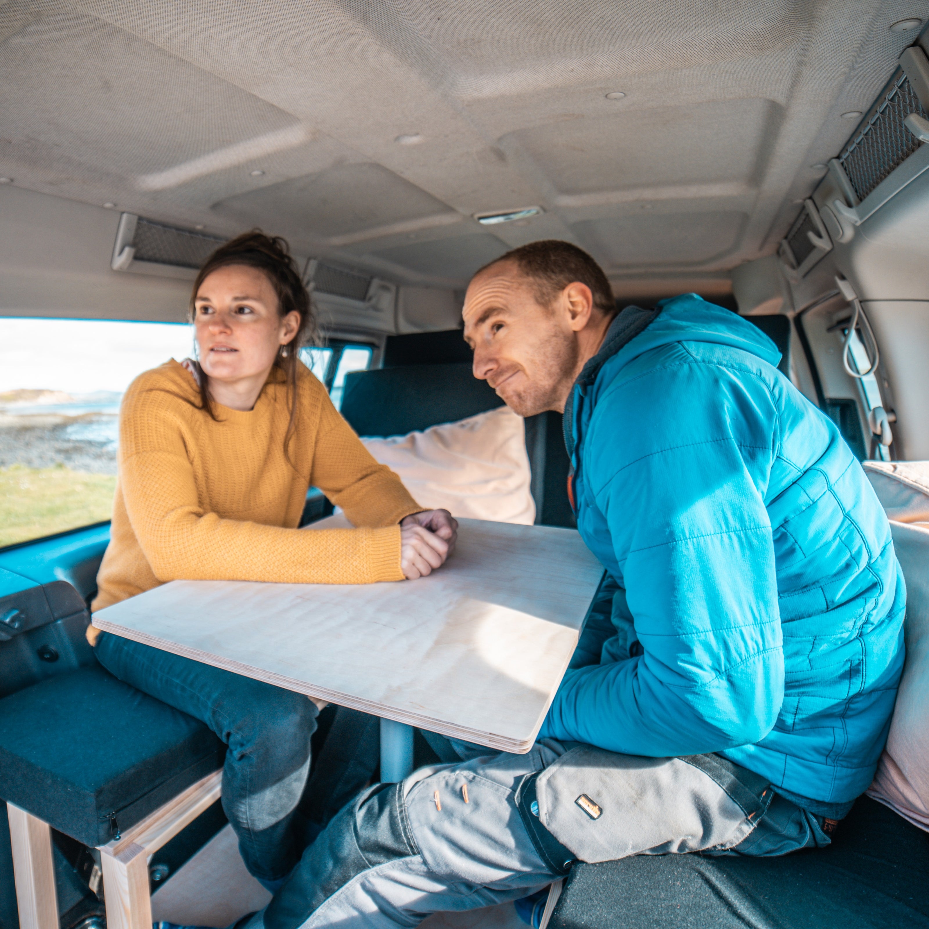 Couple relaxing in a small campervan